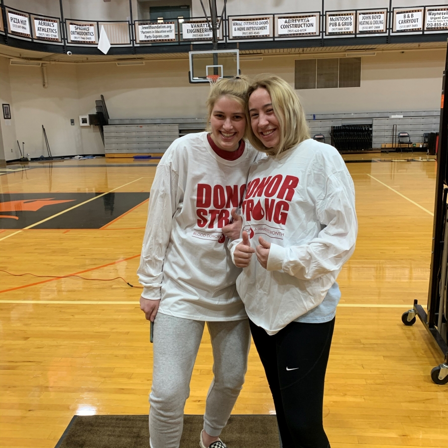 two girls wearing matching shirts